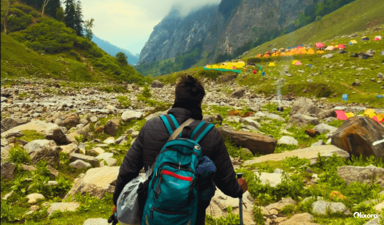 Trekkers using trekking poles on a rocky trail during a high altitude expedition