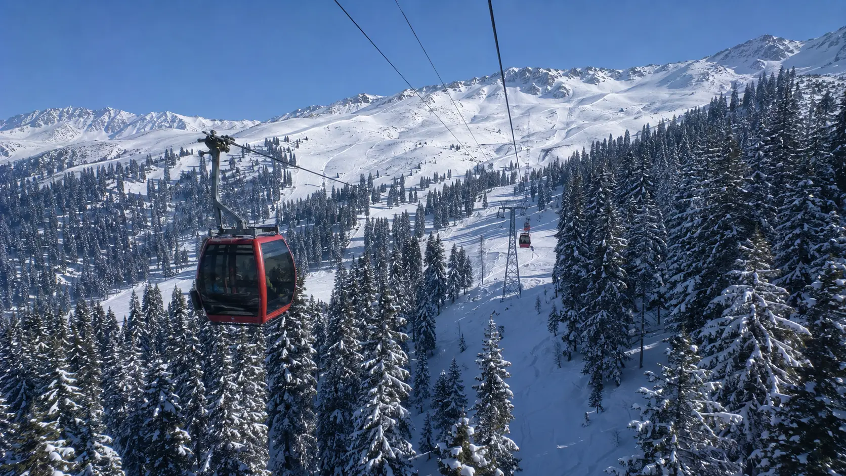 Gulmarg Gondola Phase 1 ascending over snow-covered ski slopes
